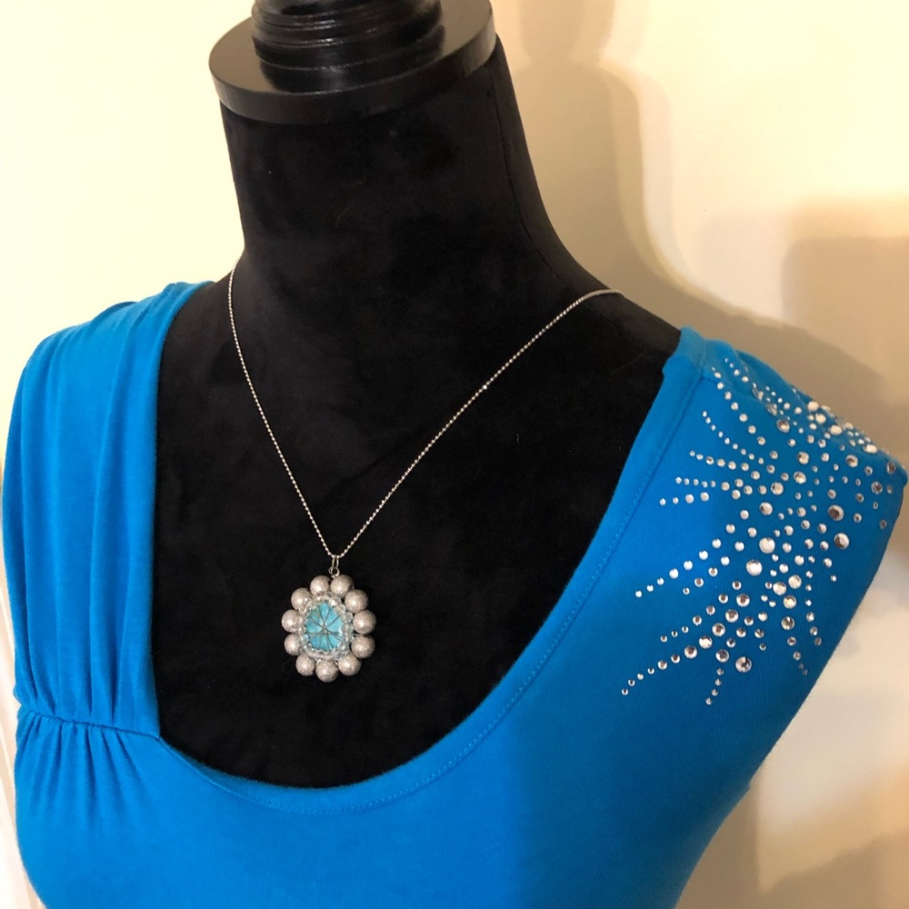 Turquoise top with shoulder bling.